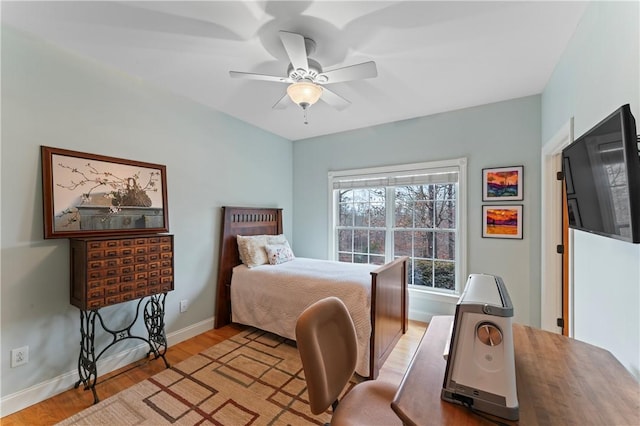 bedroom featuring light wood finished floors, ceiling fan, and baseboards