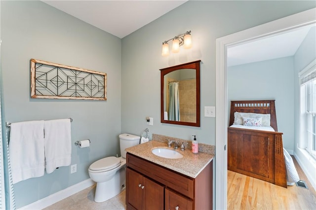 ensuite bathroom featuring toilet, vanity, ensuite bath, a shower with curtain, and baseboards