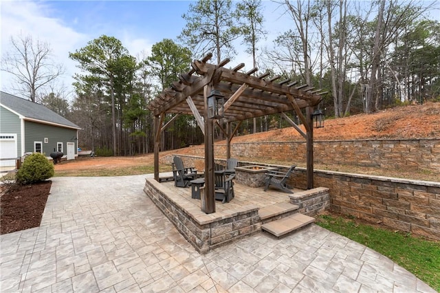 view of patio / terrace featuring an outdoor fire pit and a pergola