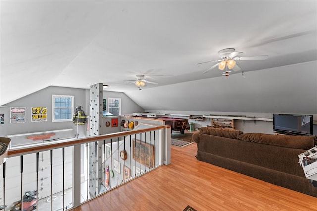 recreation room featuring lofted ceiling, ceiling fan, and wood finished floors