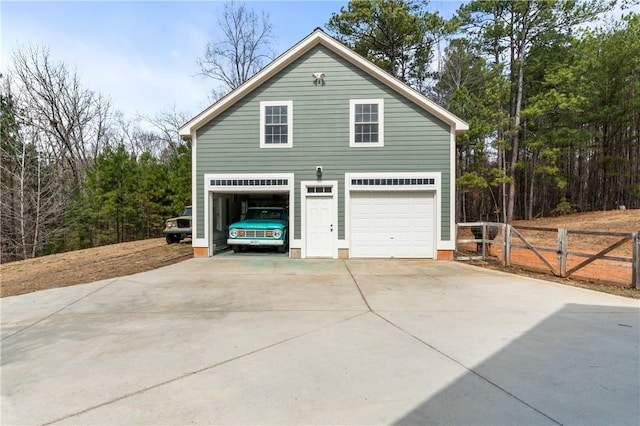 garage with a detached garage and fence