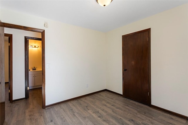 empty room featuring baseboards and wood finished floors