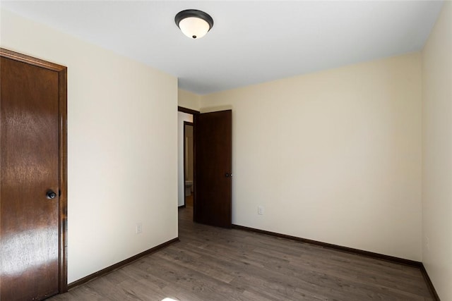 unfurnished bedroom featuring baseboards and wood finished floors