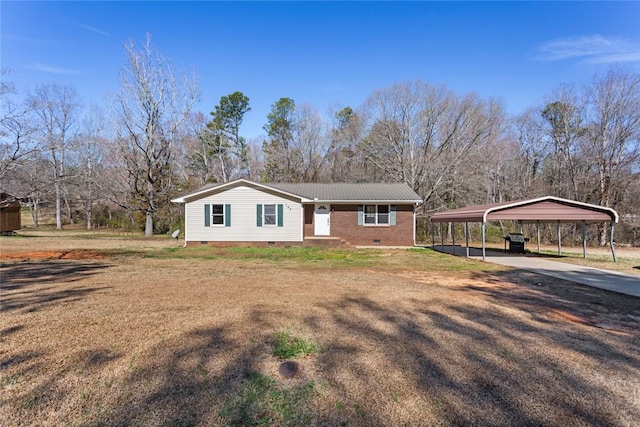 view of front of property featuring concrete driveway, a detached carport, crawl space, a front lawn, and brick siding