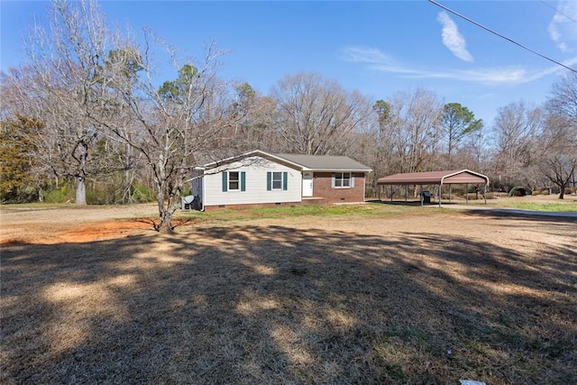 exterior space with crawl space, a carport, and a yard