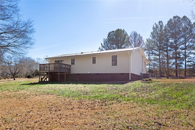 back of property featuring a deck, metal roof, cooling unit, crawl space, and a lawn