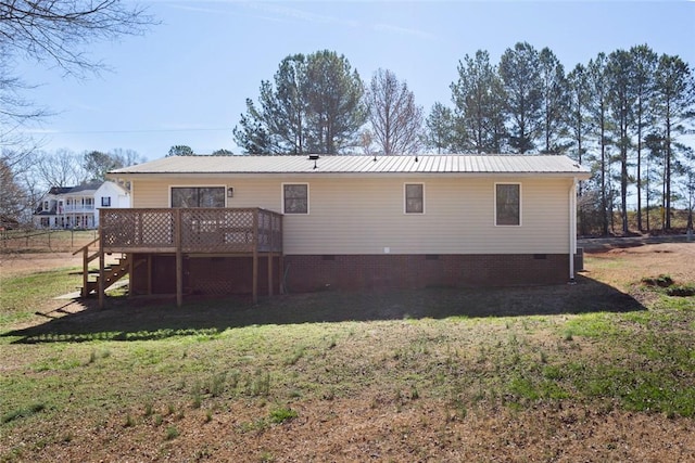 rear view of house featuring a lawn, stairway, crawl space, metal roof, and a deck