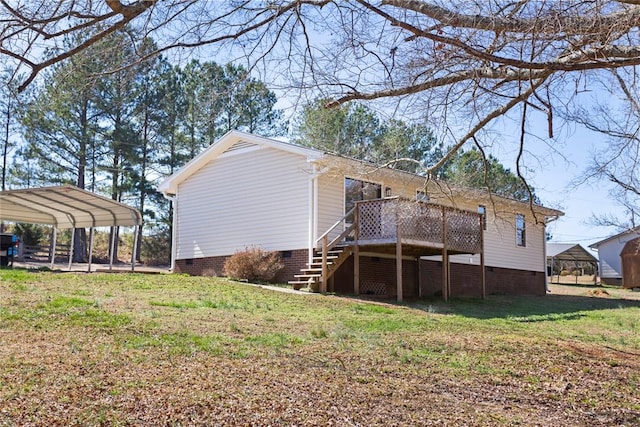 back of property with a lawn, crawl space, a carport, a wooden deck, and stairs