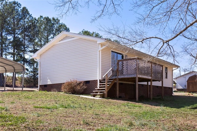 view of side of property featuring a wooden deck, crawl space, stairs, a yard, and a carport