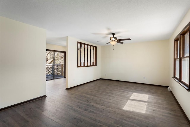 empty room featuring dark wood-style floors, ceiling fan, and baseboards