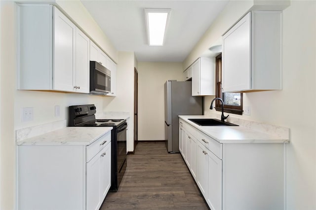 kitchen featuring stainless steel appliances, a sink, light countertops, and white cabinets