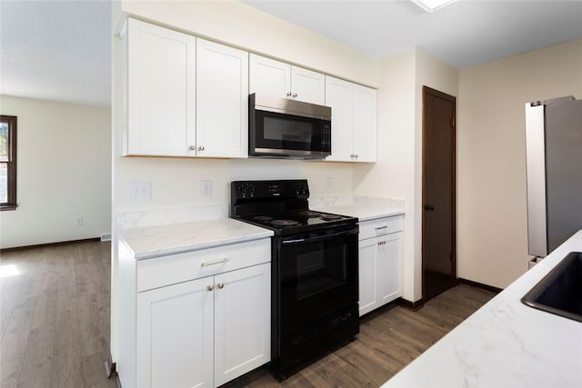 kitchen with appliances with stainless steel finishes, dark wood-style flooring, white cabinets, and light stone counters