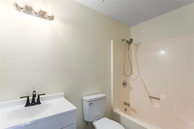 full bathroom with a textured ceiling, toilet, shower / tub combination, and vanity