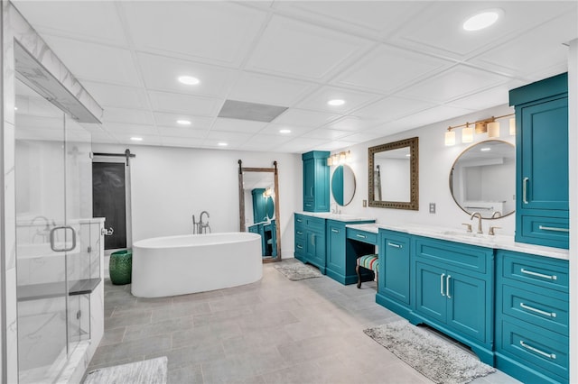 bathroom featuring a stall shower, a soaking tub, vanity, and recessed lighting