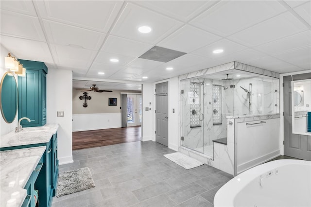 bathroom featuring a marble finish shower, a ceiling fan, a tub, vanity, and recessed lighting