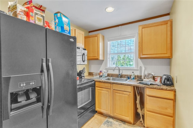 kitchen featuring black range with electric stovetop, a sink, light countertops, stainless steel fridge with ice dispenser, and light brown cabinetry