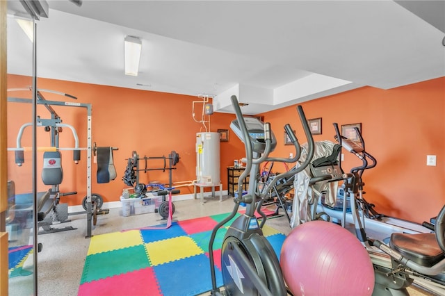 exercise room featuring water heater and baseboards