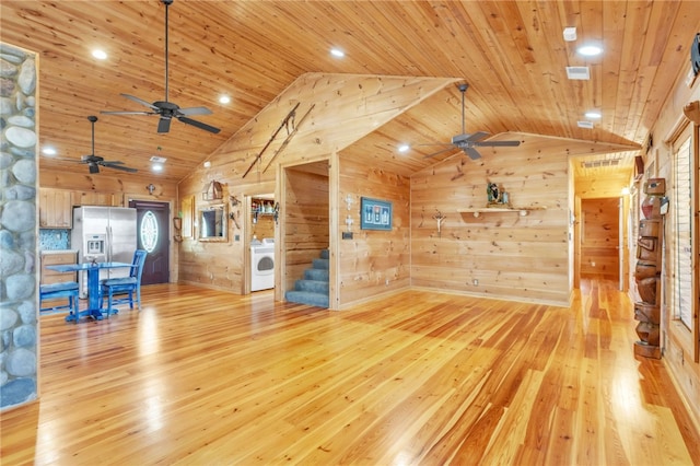 unfurnished living room with washer / dryer, wood ceiling, light wood finished floors, and stairs