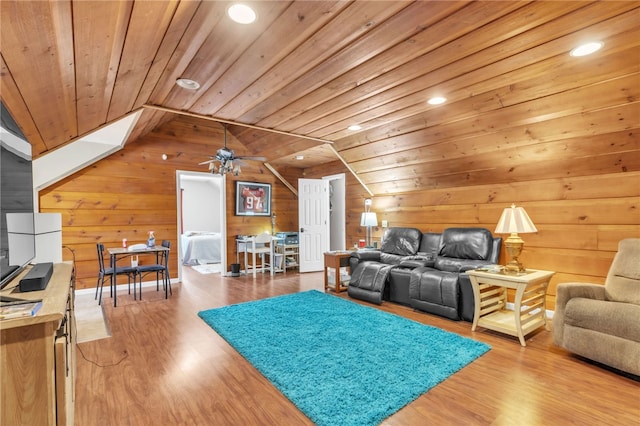 living area with lofted ceiling, wood ceiling, wooden walls, and wood finished floors