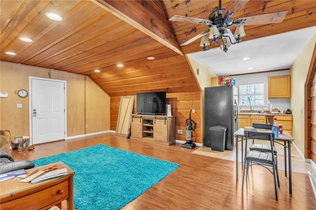 living room with vaulted ceiling, wooden ceiling, ceiling fan, and light wood finished floors