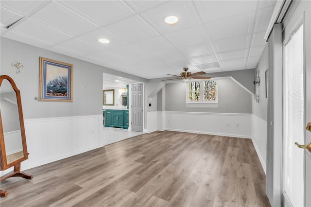 interior space with wainscoting, wood finished floors, a ceiling fan, and recessed lighting