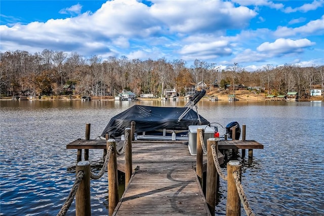 dock area with a water view and boat lift