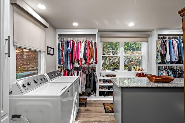 laundry area with washer and dryer, recessed lighting, and wood finished floors