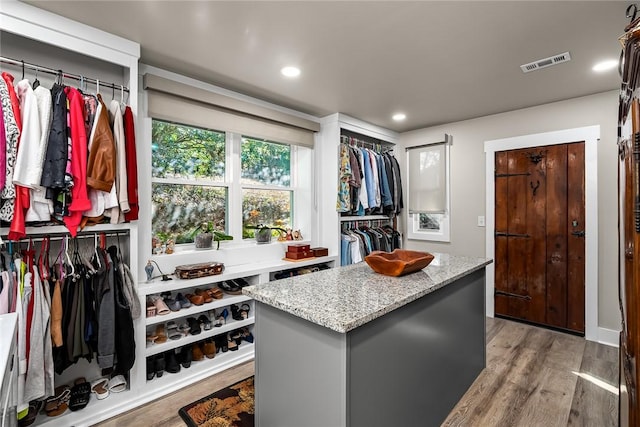 spacious closet with light wood-type flooring and visible vents