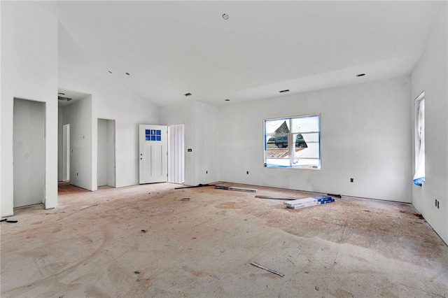 unfurnished living room featuring a towering ceiling