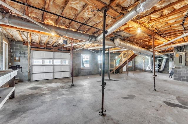 garage with electric panel, water heater, and a garage door opener