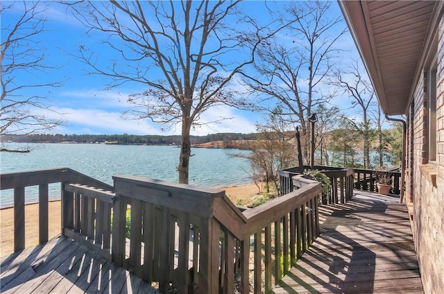 wooden terrace featuring a water view