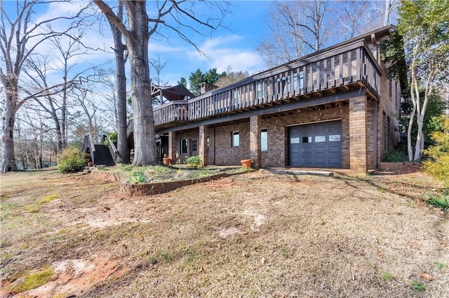 view of front facade featuring a deck, driveway, brick siding, and a garage