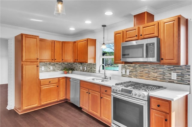 kitchen featuring ornamental molding, stainless steel appliances, a sink, and light countertops