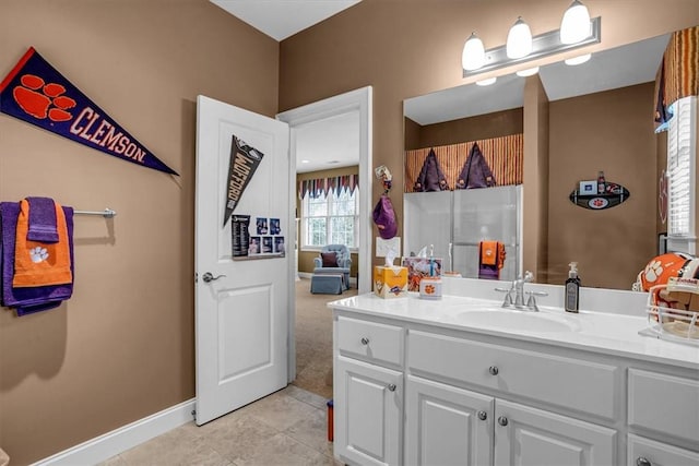 bathroom featuring tile patterned flooring, vanity, and baseboards