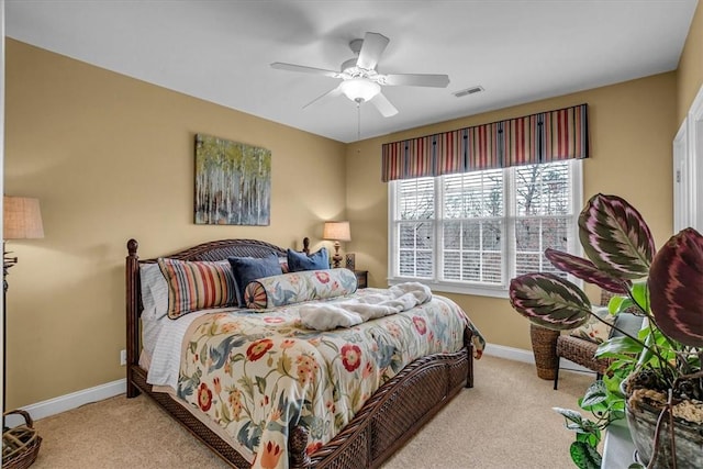 carpeted bedroom featuring visible vents, ceiling fan, and baseboards