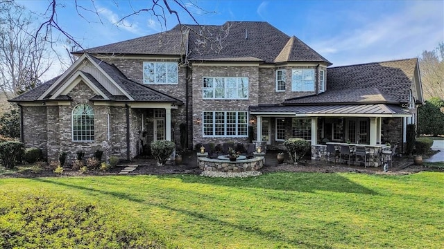 rear view of property with roof with shingles, a lawn, and brick siding