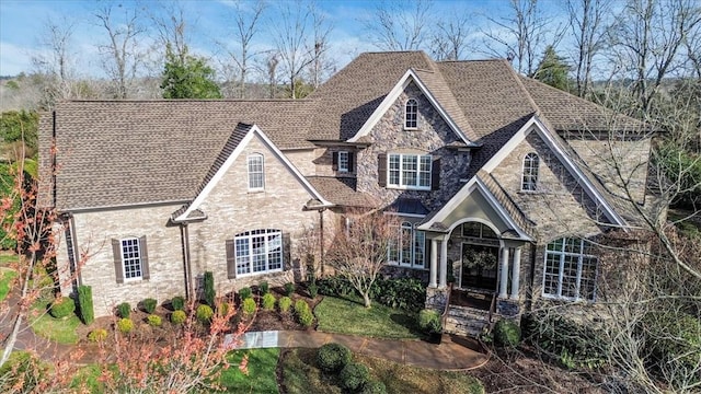 french country inspired facade with stone siding