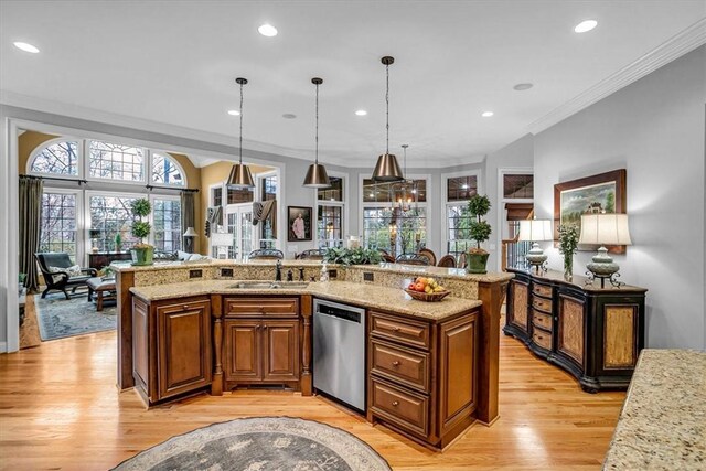 kitchen with light wood-style floors, open floor plan, ornamental molding, brown cabinets, and dishwasher