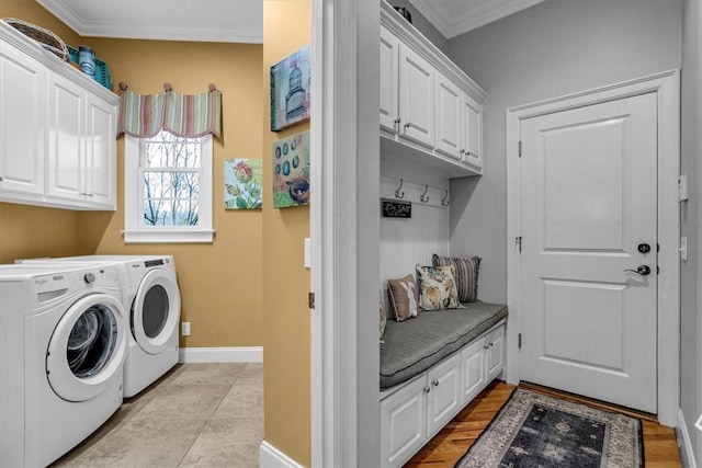 laundry area with ornamental molding, cabinet space, washer and clothes dryer, and baseboards