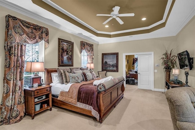 bedroom with ornamental molding, a tray ceiling, light colored carpet, and recessed lighting