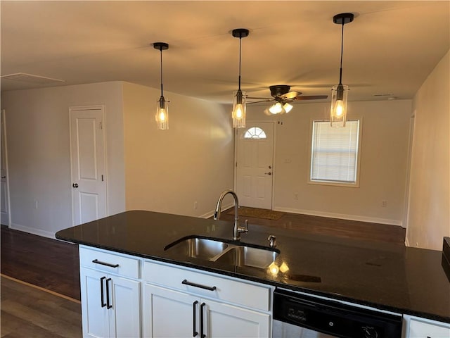 kitchen with pendant lighting, white cabinetry, dishwasher, and a sink