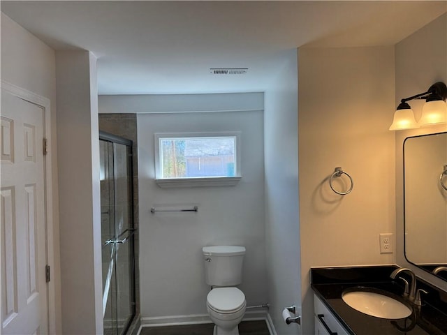 bathroom with visible vents, baseboards, toilet, vanity, and a shower stall