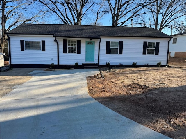 single story home featuring concrete driveway