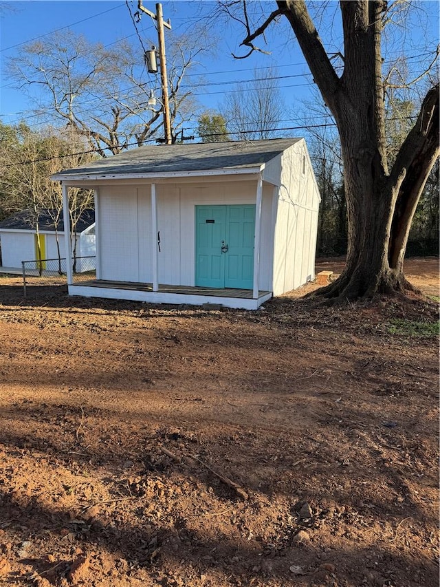 view of shed featuring fence