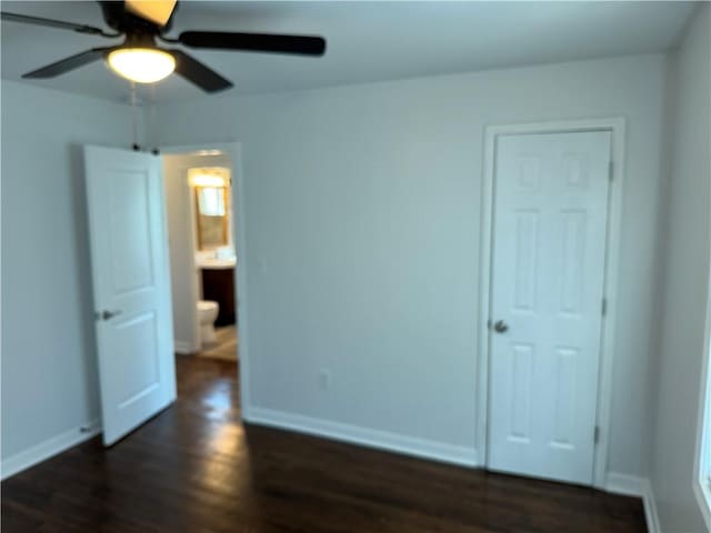 unfurnished bedroom with dark wood-style floors, baseboards, and a ceiling fan