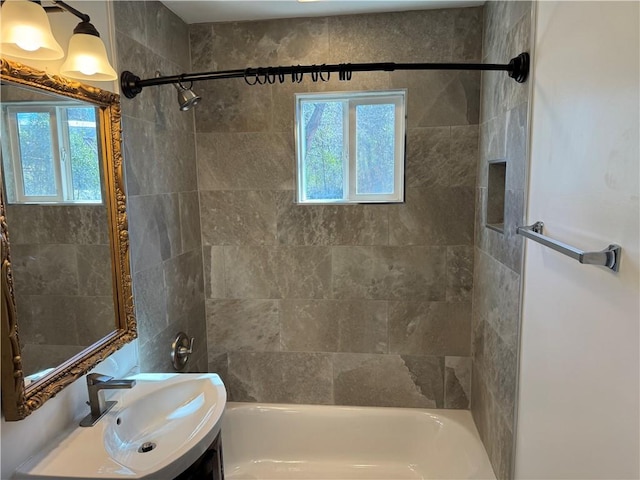 bathroom featuring  shower combination, a wealth of natural light, and vanity