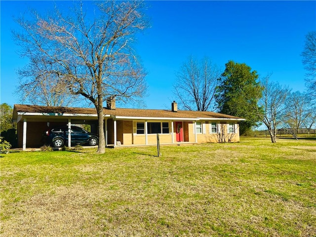 ranch-style home with a carport, a chimney, and a front yard