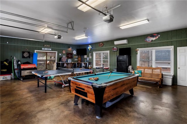 game room featuring a garage, pool table, finished concrete floors, and a wall mounted AC