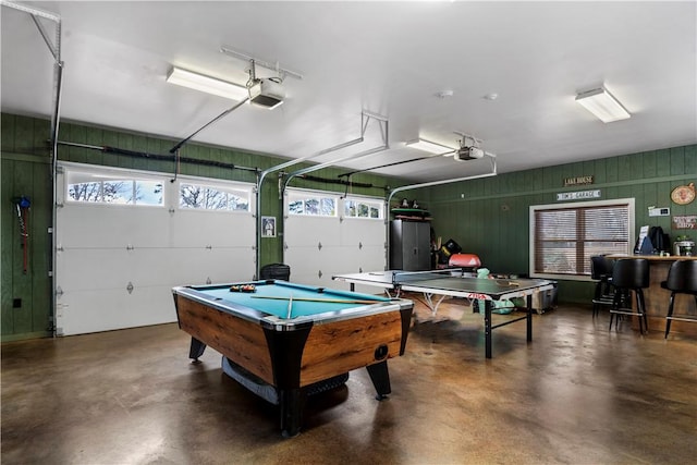 rec room featuring a garage and finished concrete floors