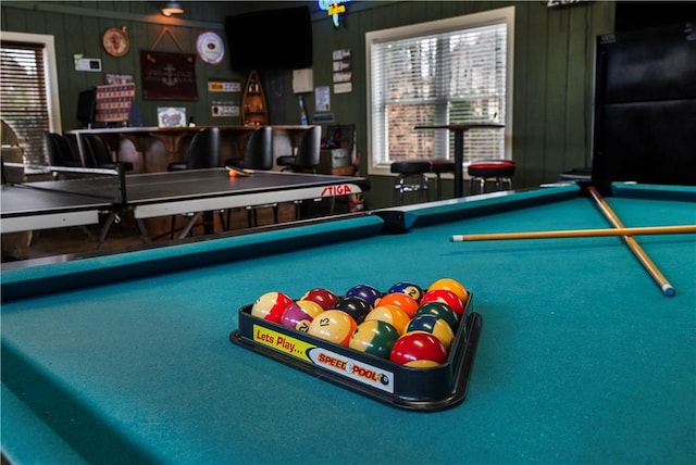 playroom with pool table and a bar